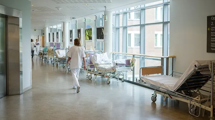Health care worker walking in a hospital hallway