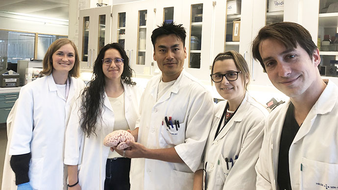 Image of Evandro Fei Fang and some of his fellow researchers